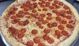 A pepperoni pizza is shown with many toppings.